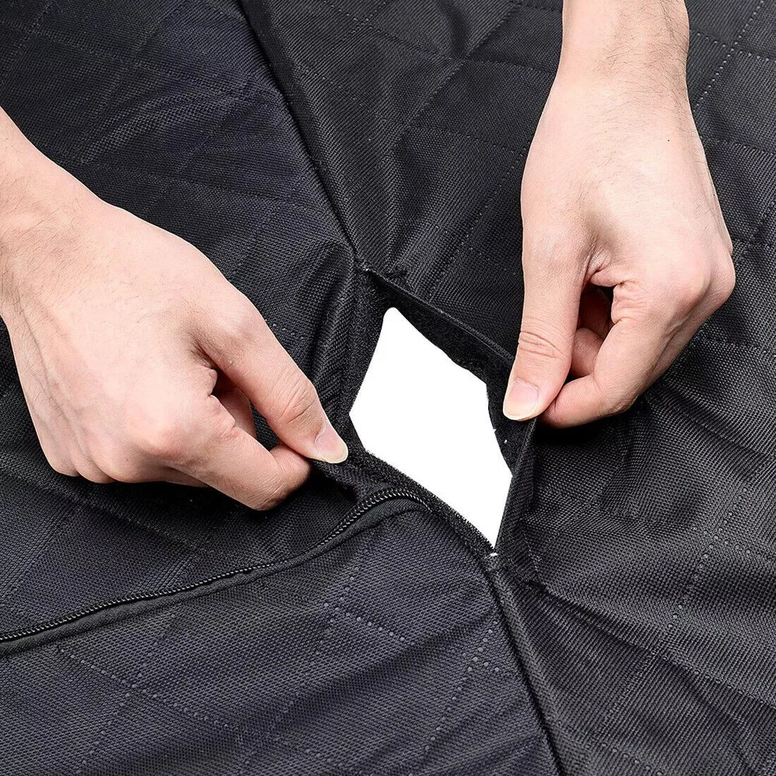 Hands opening the zipped section in the quilted hammock