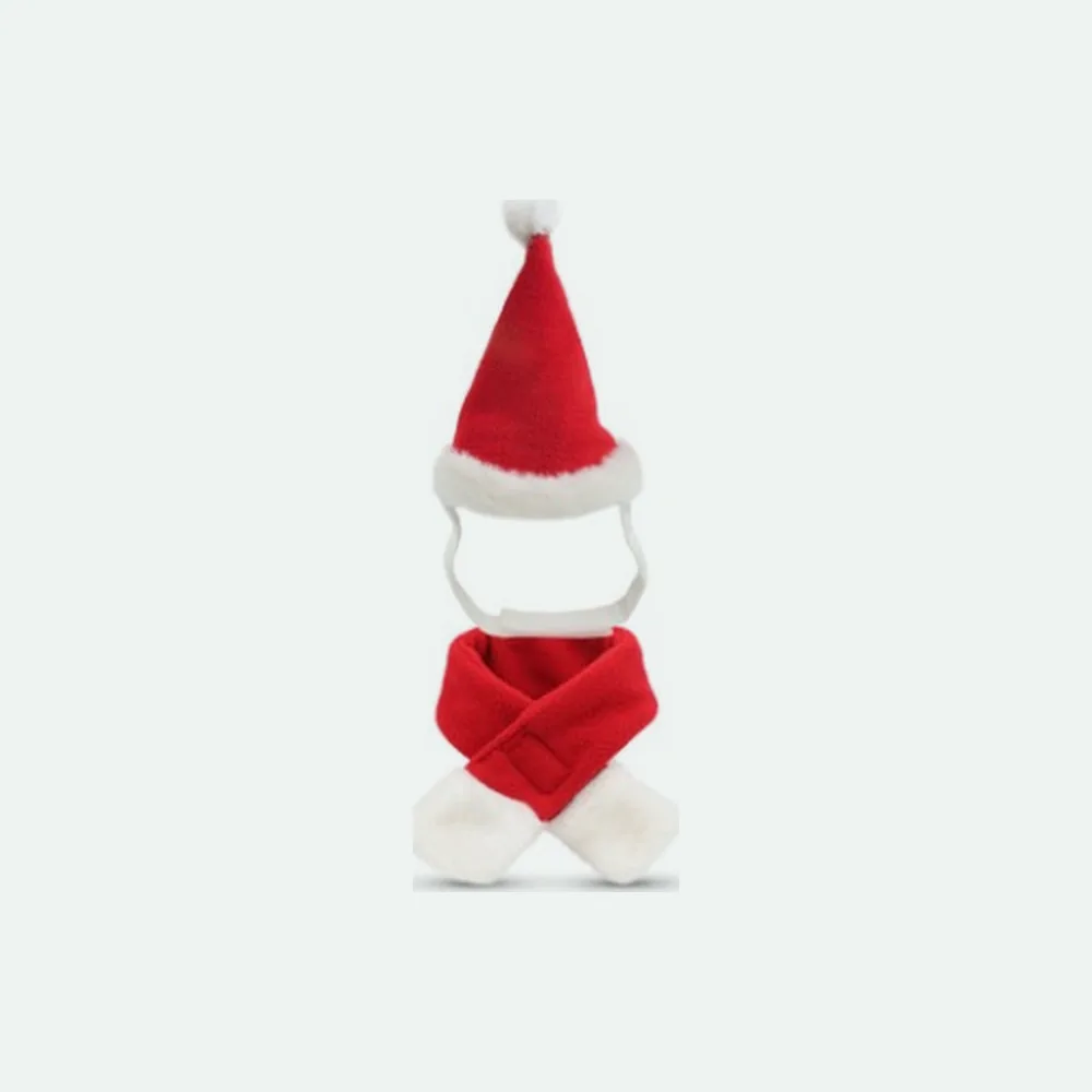 The red plush Santa hat with its elastic strap above the matching scarf with white ends