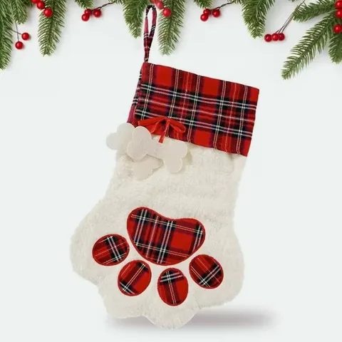Paw-shaped cream plush Christmas stocking with a red tartan cuff, tartan paw pads and a felt bone