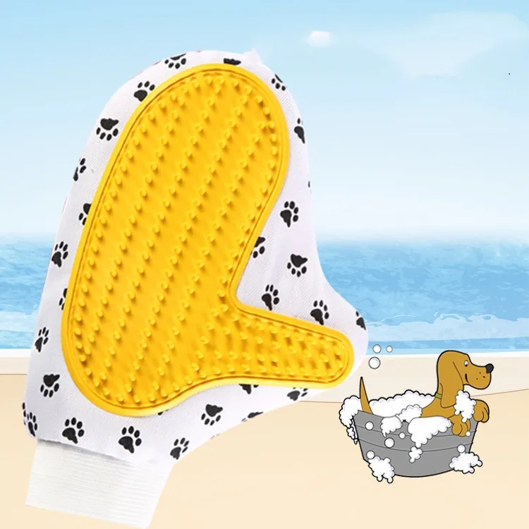 Grooming glove with a yellow silicone nub pad on white paw-print fabric